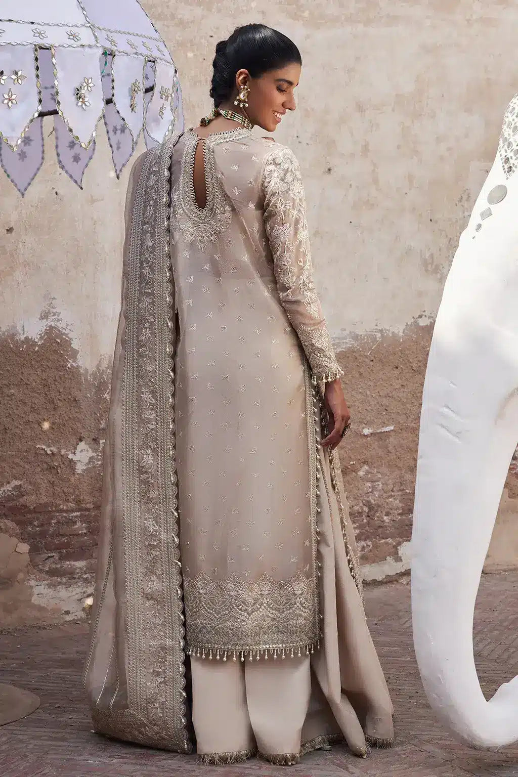 Afrozeh Dastangoi Wedding Formals Ulfat – Ivory Pakistani Dress with intricate embroidery and embellishments. Shop elegant Asian dresses at Maria Faisal.